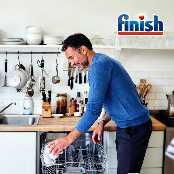 Man loading dishwasher while following instructions from Dishwasher Pro skill developed by Finish and Vixen Labs.