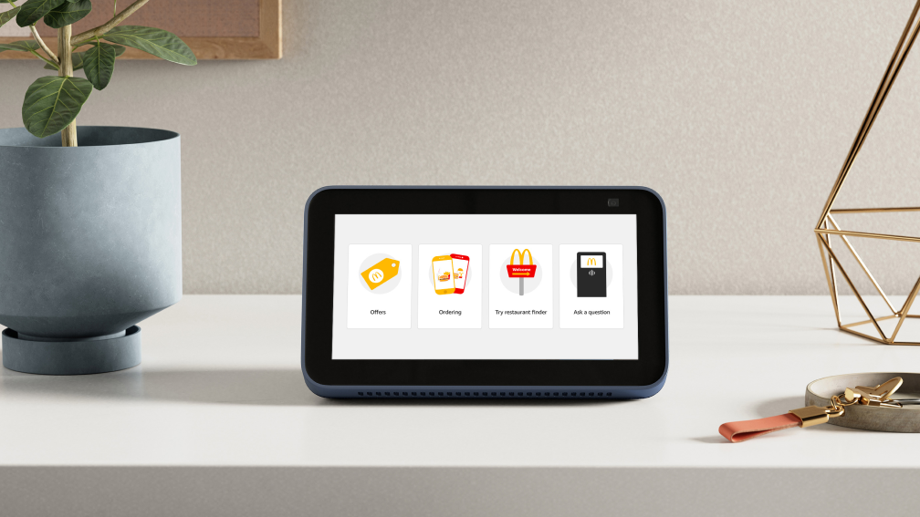 Screenshot of official McDonald's Amazon skill UK on an Alexa Device, featuring the welcome screen, with restaurant finder, offers, orders and ask a question.