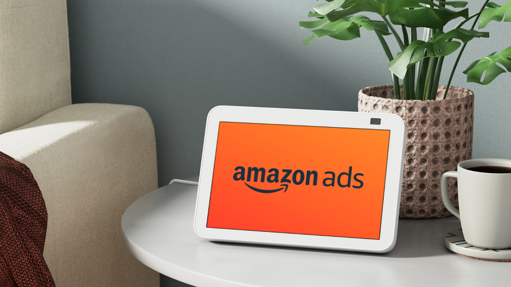 White Alexa device with "Amazon Ads" writing on screen.